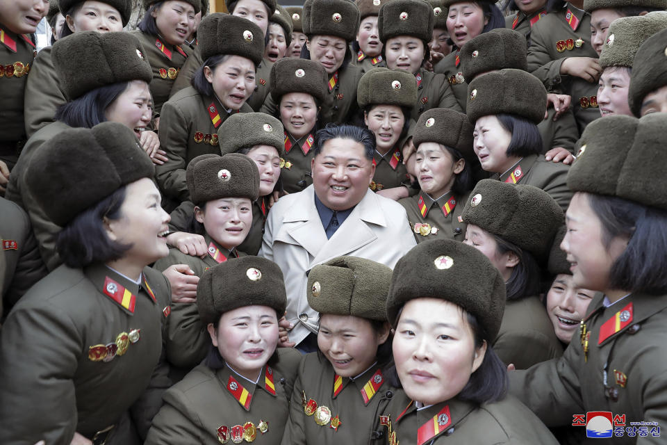 In this undated photo provided on Monday, Nov. 25, 2019, by the North Korean government, North Korean leader Kim Jong Un, center, poses as he inspects a women's company under Unit 5492 of the Korean People's Army in North Korea. Independent journalists were not given access to cover the event depicted in this image distributed by the North Korean government. The content of this image is as provided and cannot be independently verified. Korean language watermark on image as provided by source reads: "KCNA" which is the abbreviation for Korean Central News Agency. (Korean Central News Agency/Korea News Service via AP)