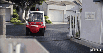 Two women riding a golf cart