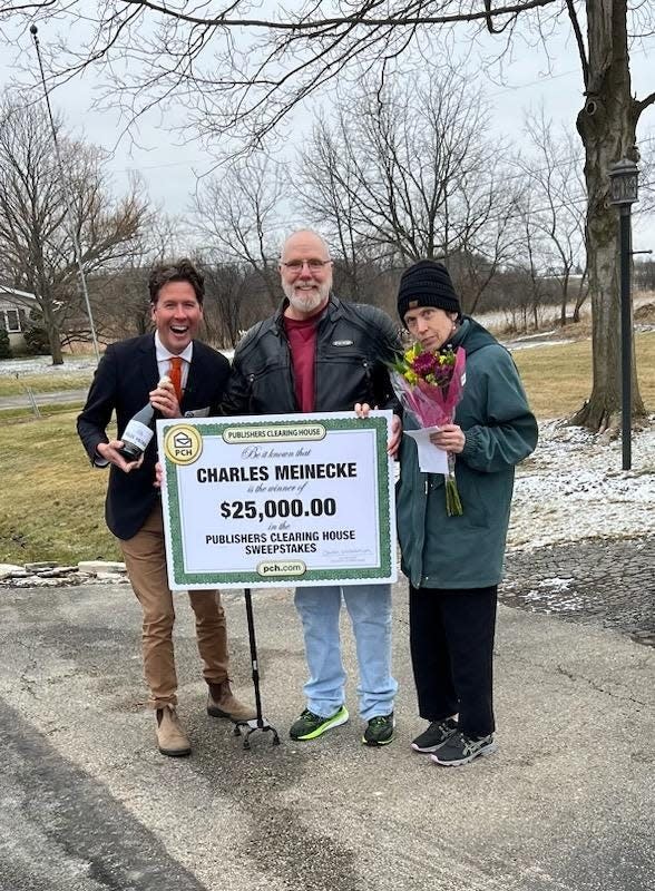 Howie Guya, a member of the prize patrol from the Publishers Clearing House, awarded a $25,000 check to Charles Meinecke in Menomonee Falls. Pictured left to right: Guya, Meinecke and Danielle Meinecke.