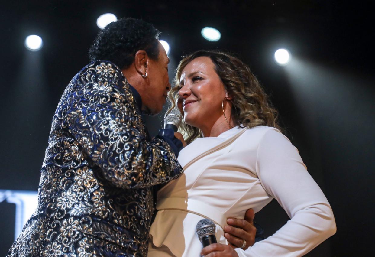 Smokey Robinson shares a microphone with a backup singer on the Palomino Stage during the Stagecoach country music festival in Indio, Calif., Sunday, May 1, 2022. 