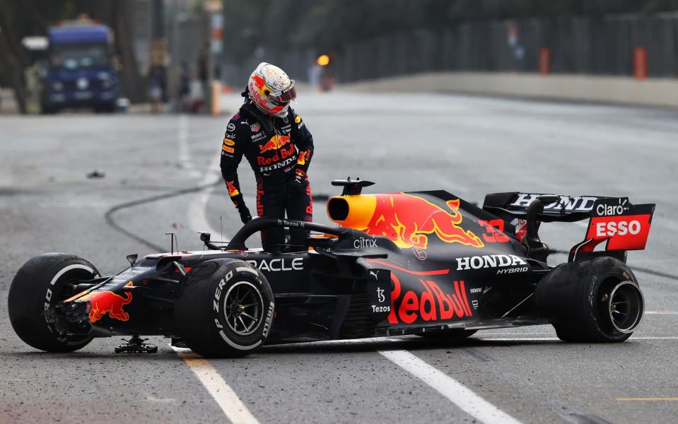 Verstappen looks incredulously at the failed tyre that caused his crash - GETTY IMAGES