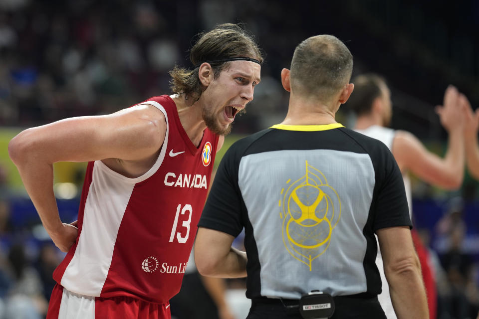 Canada forward Kelly Olynyk has a word with the referee during a Basketball World Cup semi final game in Manila, Philippines, Friday, Sept. 8, 2023. (AP Photo/Aaron Favila)