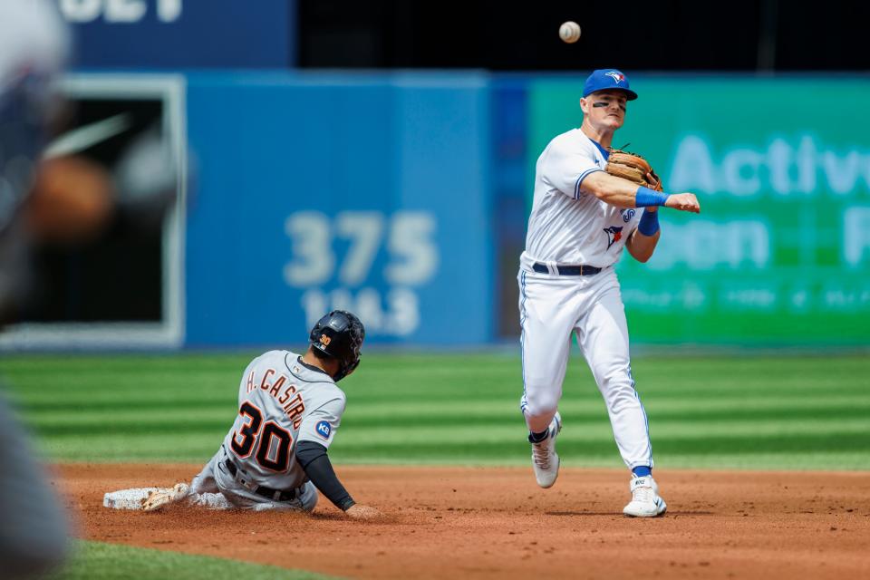 Blue Jays infielder Matt Chapman makes a throw to first as Tigers infielder Harold Castro is forced out; Tigers outfielder Robbie Grossman reached first base on the play the second inning at Rogers Centre on July 31, 2022 in Toronto, Canada.