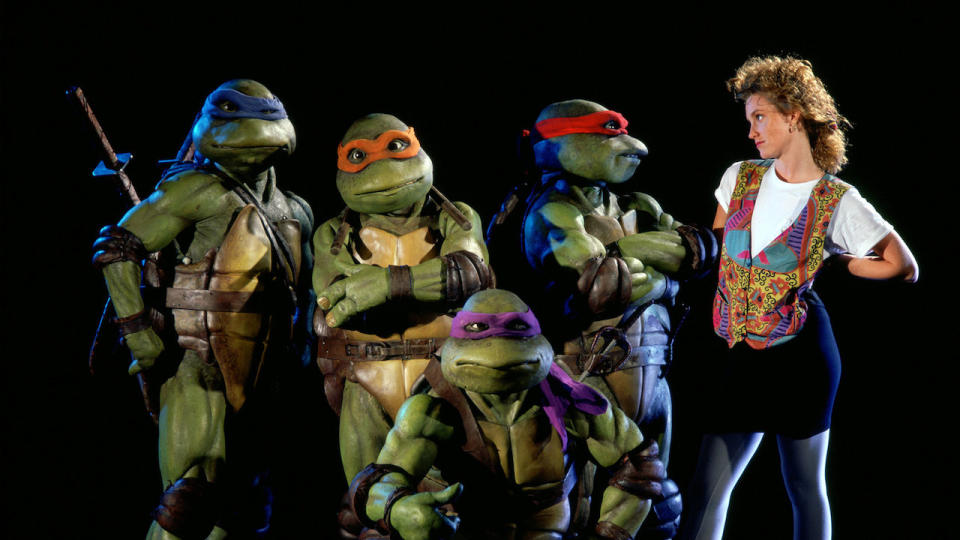 A publicity still for Teenage Mutant Ninja Turtles shows Leonardo, Michaelangelo, Donatello, Raphael and Judith Hoag as reporter April O'Neil. (New Line Cinema)