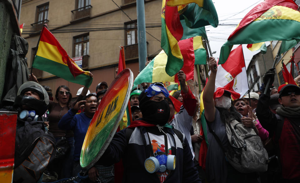 Anti-government protesters against the reelection of President Evo Morales gather just meters away from the presidential palace in La Paz, Bolivia, Saturday, Nov. 9, 2019. Policemen guarding the exteriors of the presidential palace in La Paz retreated to their barracks on Saturday, while officers in other Bolivian cities have declared mutinies and joined protests against Morales, who has faced two weeks of unrest over disputed election results. (AP Photo/Juan Karita)