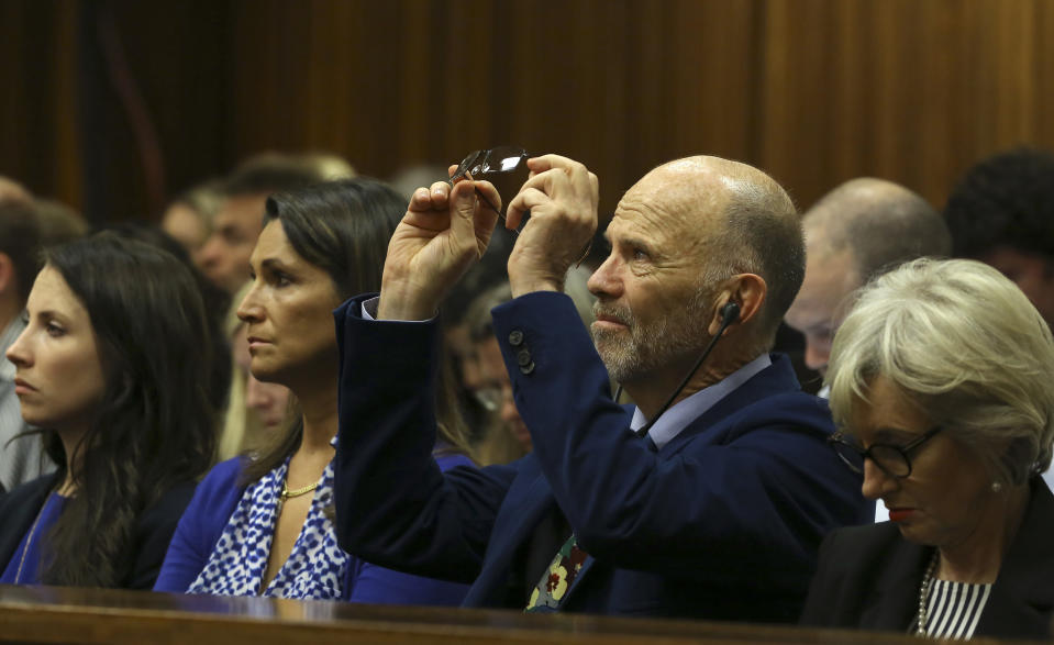 Oscar Pistorius's uncle Arnold Pistorius sits with family members during his nephew's trial at the high court in Pretoria, South Africa, Thursday, March 13, 2014. Oscar Pistorius is charged with murder for the shooting death of his girlfriend Reeva Steenkamp on Valentine's Day in 2013. (AP Photo/Themba Hadebe, Pool)