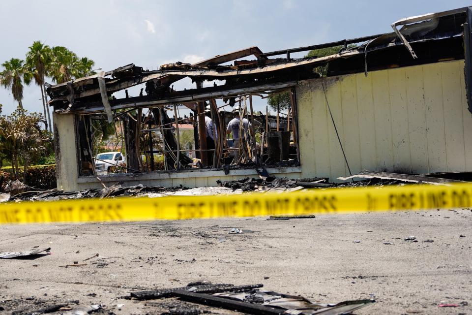 Police investigators walk through the remains of Vero Beach Laundry & Cleaners and Kids Closet of Vero Beach on Wednesday, May 18, 2022, in Vero Beach. Both businesses were involved in an overnight fire first reported at 9:15 p.m. Tuesday, May 17, 2022. A State Fire Marshal investigation is underway to determine the cause.