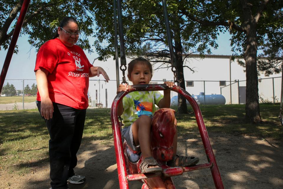 Natasha Eagle Star pushes her son Noran on a swing at the Winner City Park on Tuesday, Aug. 29, 2023.