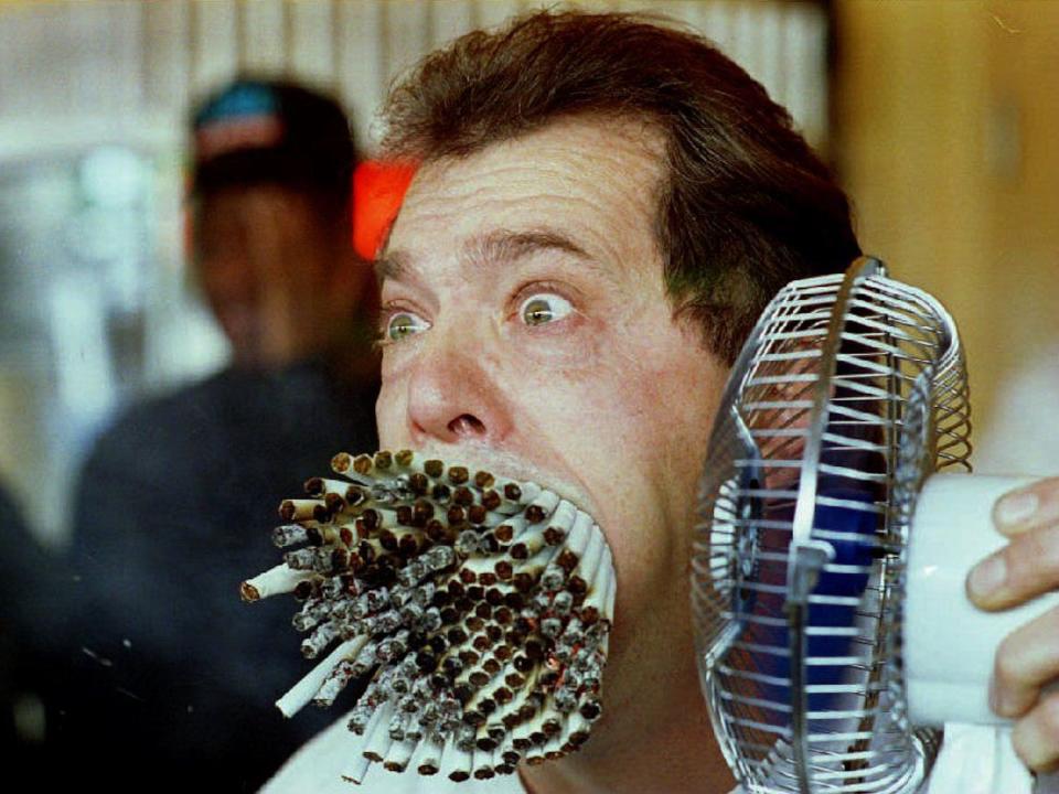 Jim Mouth smokes 155 cigarettes as he breaks "The Guinness Book of World Records" record in 1993.