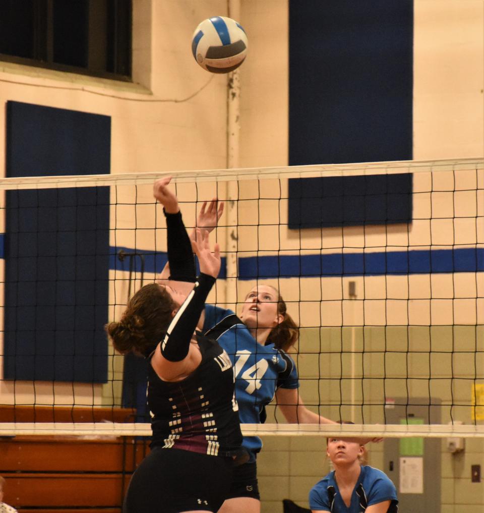 Dolgeville's Katelyn Seeley (14) and Port Byron's Morgan Reif converge on the ball at the net during a first round Section III playoff match Tuesday.