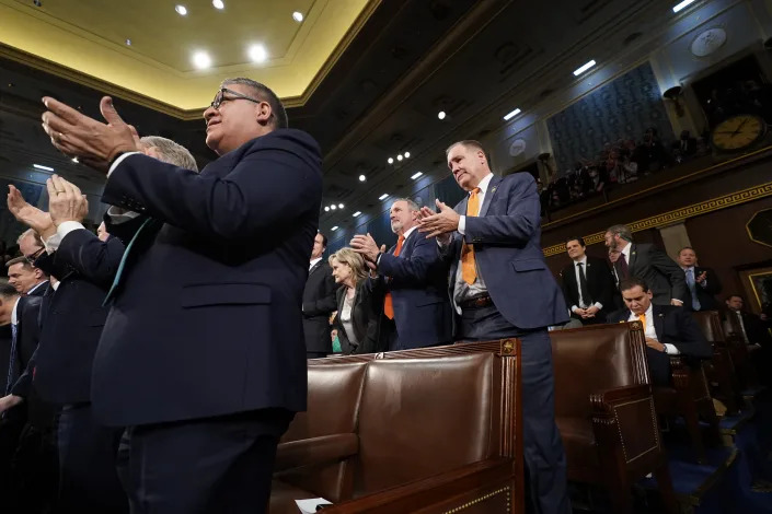 Rep. George Santos, R-N.Y., sits as other Republicans stand as President Joe Biden talks about American manufacturing during the State of the Union address to a joint session of Congress at the Capitol, Tuesday, Feb. 7, 2023, in Washington. (Jacquelyn Martin, Pool)