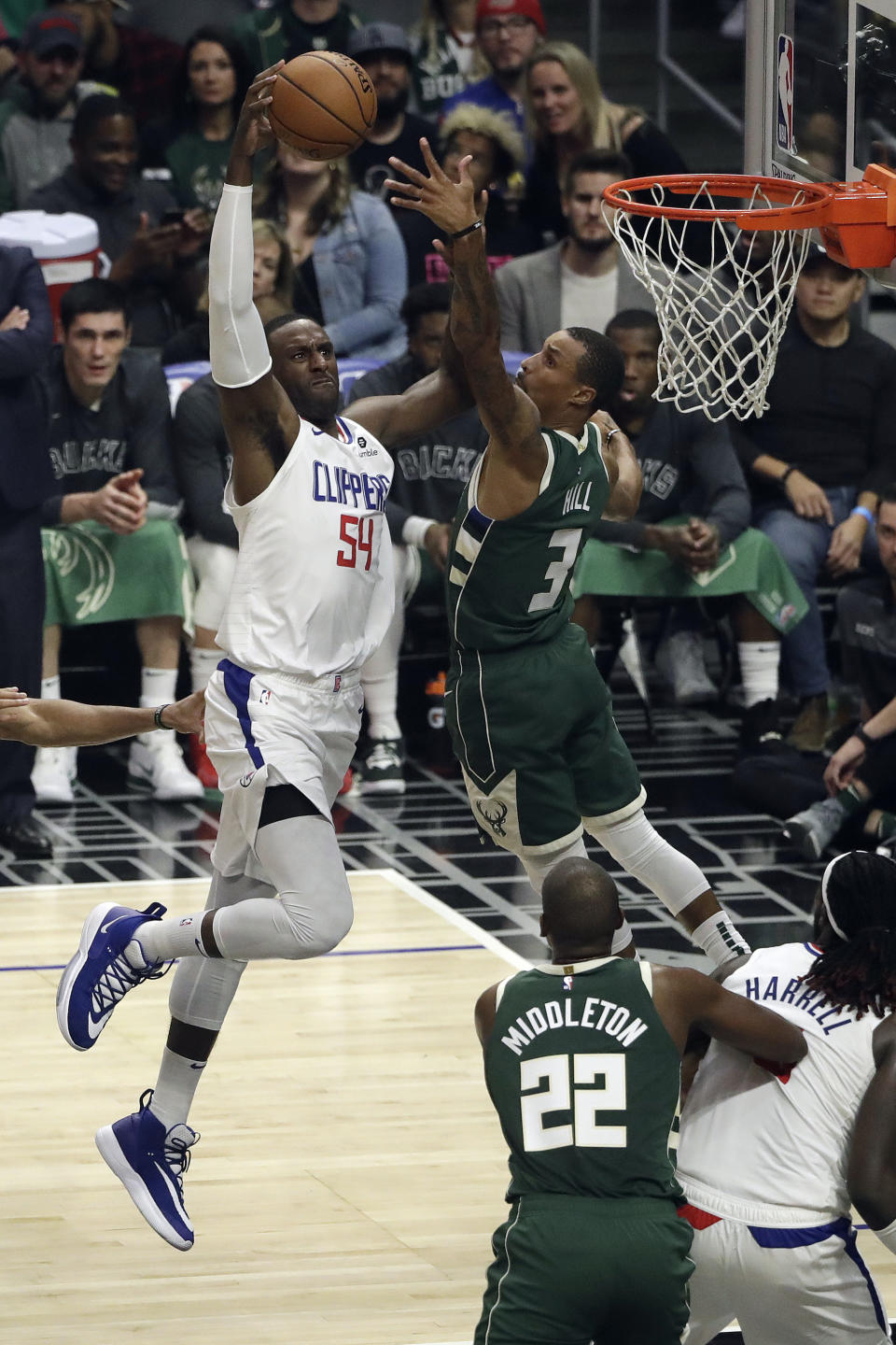 Los Angeles Clippers' Patrick Patterson (54) dunks past Milwaukee Bucks' George Hill (3) during the first half of an NBA basketball game Wednesday, Nov. 6, 2019, in Los Angeles. (AP Photo/Marcio Jose Sanchez)