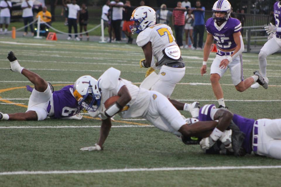 Calvary Day's Emerson Lewis makes a tackle on Beach's Shareefe Morgan in Calvary Day's win over the Bulldogs on Aug. 16, 2024.