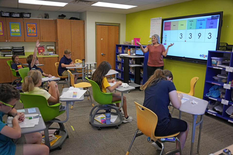 Elementary math teacher Margie Howells teaches a fifth grade class at Wheeling Country Day School in Wheeling, W.Va., on Tuesday, Sept. 5, 2023. Howells said that she turned to the science of math after wondering why there weren't as many resources for dyscalculia as there were for dyslexia. Reading the research helped her become more explicit about things that she assumed students understood, like the fact that the horizontal line in a fraction means the same thing as a division sign. "I'm doing a lot more instruction in vocabulary and symbol explanations so that the students have that built-in understanding," said Howells. (AP Photo/Gene J. Puskar)