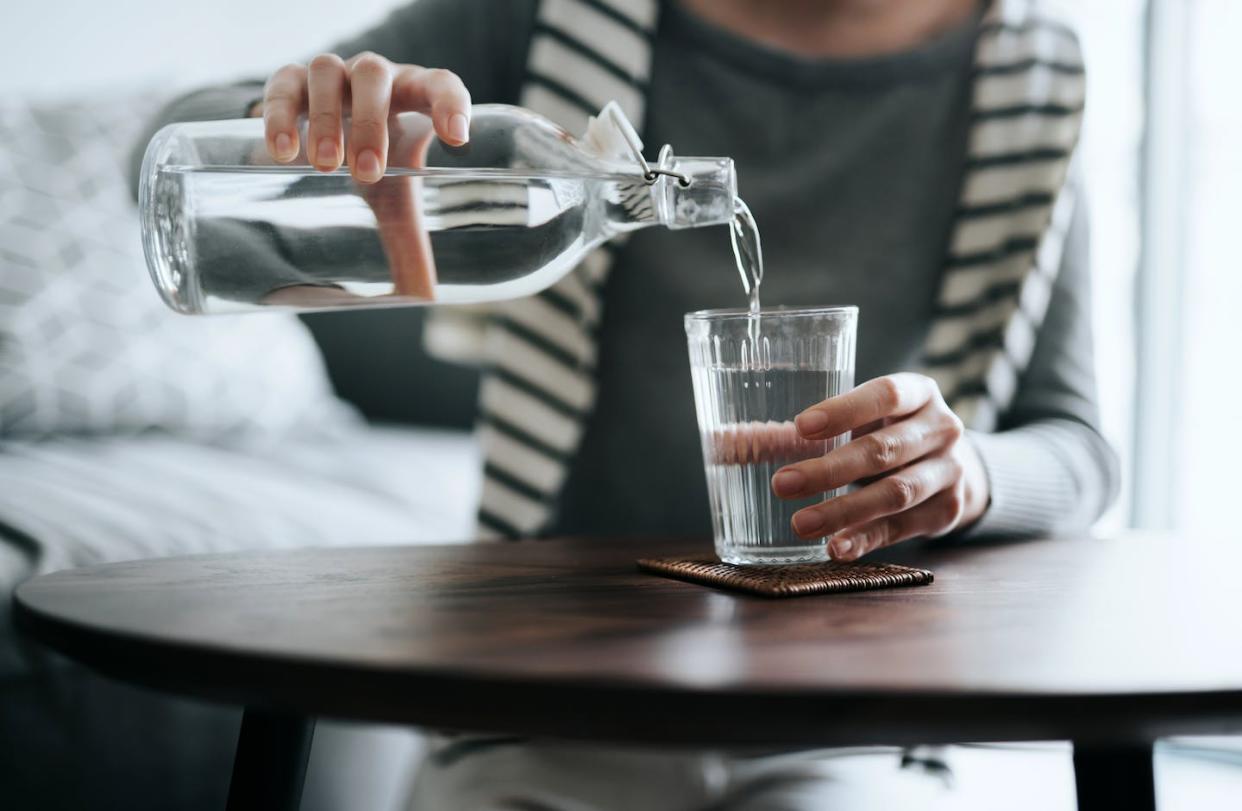 PFAS can be found in hundreds of water systems in the U.S. <a href="https://www.gettyimages.com/detail/photo/close-up-of-young-asian-woman-pouring-water-from-royalty-free-image/1299286918?phrase=pouring%20water%20into%20glass&adppopup=true" rel="nofollow noopener" target="_blank" data-ylk="slk:d3sign/Moment via Getty Images;elm:context_link;itc:0;sec:content-canvas" class="link ">d3sign/Moment via Getty Images</a>