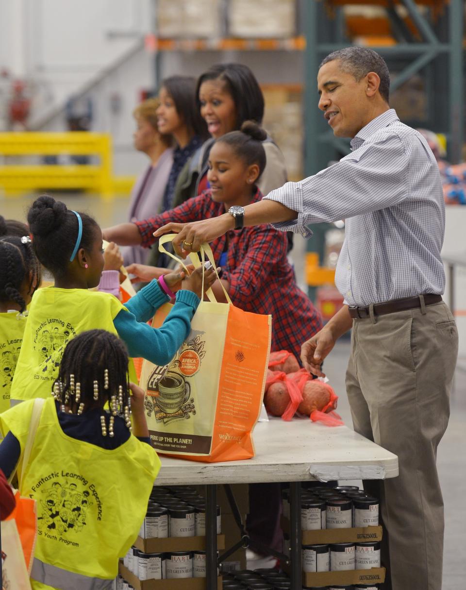 The Obamas distributed food at the Capitol Area Food Bank in Washington, DC, in 2012. (Photo: MANDEL NGAN via Getty Images)