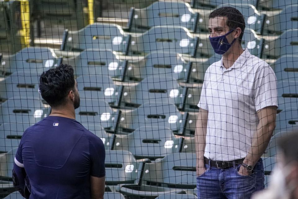 Milwaukee Brewers general manager David Stearns talks to Ryan Braun during a practice session Saturday, July 4, 2020, at Miller Park in Milwaukee. (AP Photo/Morry Gash)