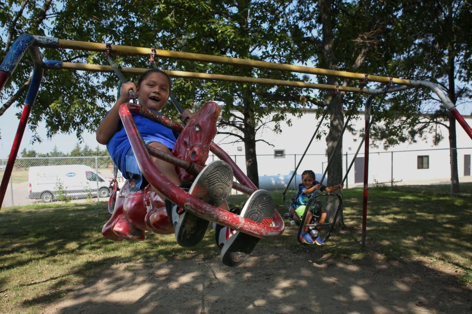 Natasha and Jessica Eagle Star’s sons Brayden and Julius (left to right) swing at the Winner City Park on Tuesday, Aug. 29, 2023.