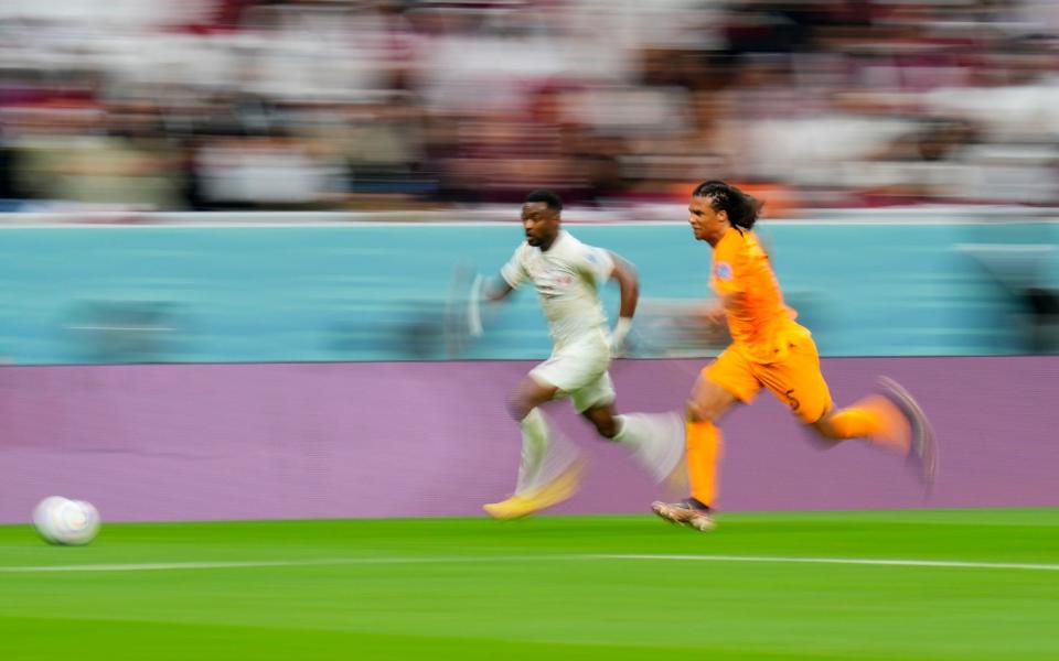 Nathan Ake of the Netherlands, right, and Qatar's Ismail Mohamad chase the ball during a World Cup group A soccer match at the Al Bayt Stadium - AP Photo/Petr David Josek)