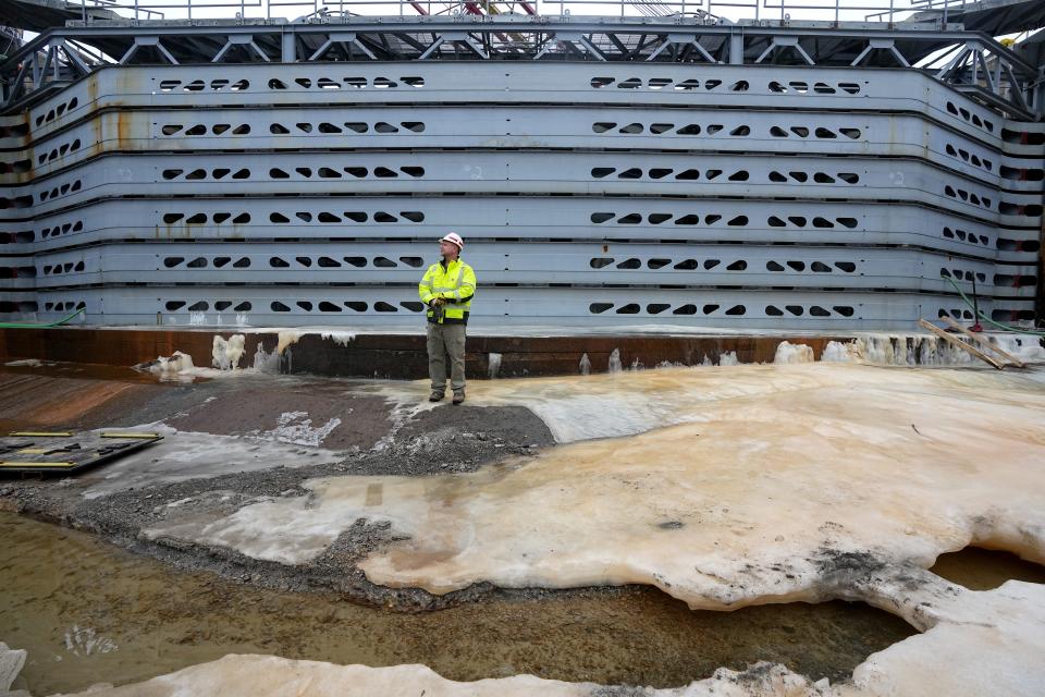 A worker stands in front of the bulkhead that prevents water from entering Lock and Dam No. 2 on Jan. 30 on the Mississippi River in Hastings, Minnesota.