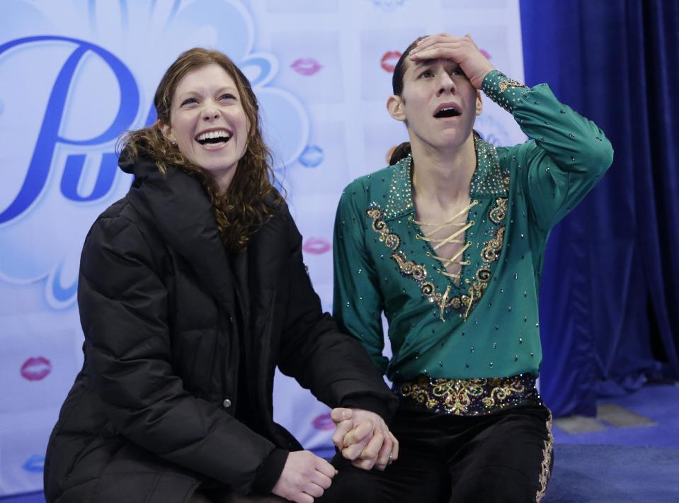 Jason Brown, right, celebrates with his coach Kori Ade, left, as he learns his scores after competing in the men's free skate at the U.S. Figure Skating Championships Sunday, Jan. 12, 2014 in Boston. (AP Photo/Steven Senne)