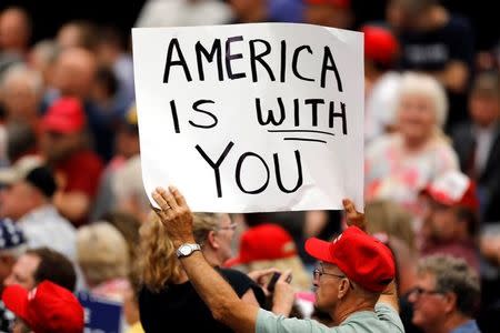 A supporter holds a sign during a rally with President Donald Trump at the U.S. Cellular Center in Cedar Rapids, Iowa, U.S. June 21, 2017. REUTERS/Scott Morgan