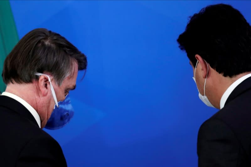 Brazil's President Jair Bolsonaro and Minister of Health Luiz Henrique Mandetta walk after a press statement during the coronavirus disease (COVID-19) outbreak in Brasilia