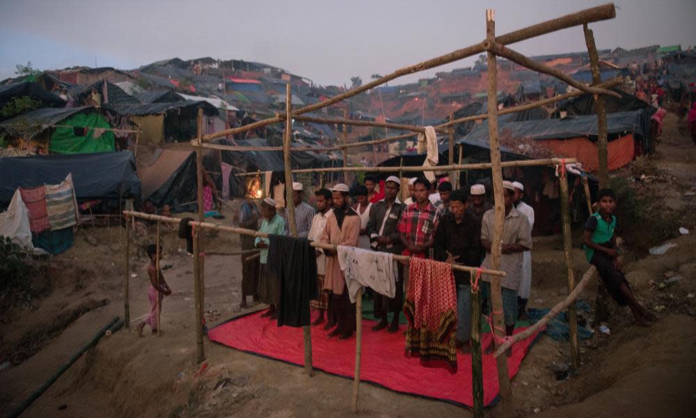 Rohingya Muslims say their evening prayers in a half completed structure at a refugee camp in Bangladesh. 