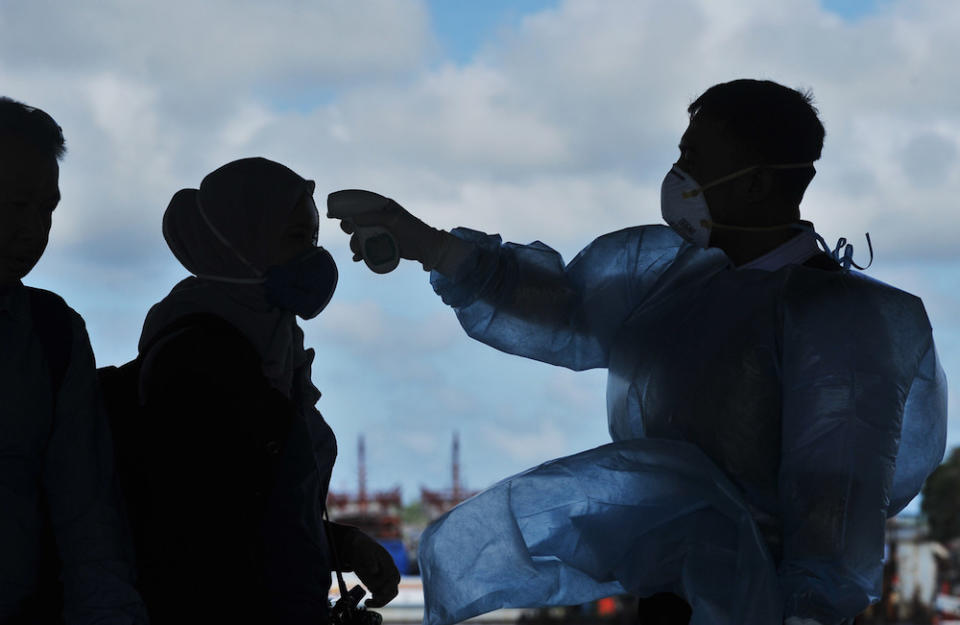 The ministry explained that a video showing a masked person dressed in the white protective suit leading a group of people into a beige-coloured van was part of its routine procedures. — Bernama pic