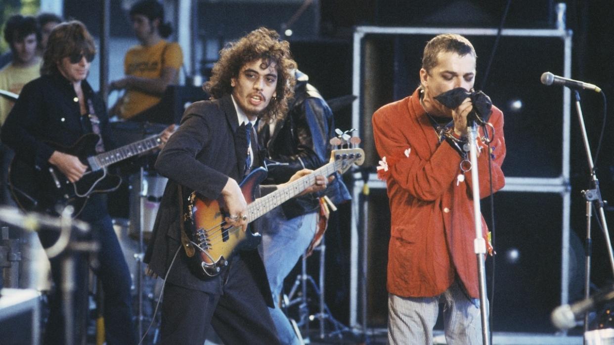  Norman Watt-Roy, Ian Dury and the Blockheads, performing on stage, Alkmaar Pop Festival, AZ 67 Stadion, Alkmaar, Netherlands, 17th June 1978. 