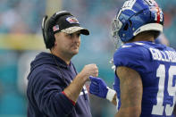 New York Giants head coach Joe Judge fist bumps wide receiver Kenny Golladay (19) during the second half of an NFL football game against the Miami Dolphins, Sunday, Dec. 5, 2021, in Miami Gardens, Fla. (AP Photo/Lynne Sladky)