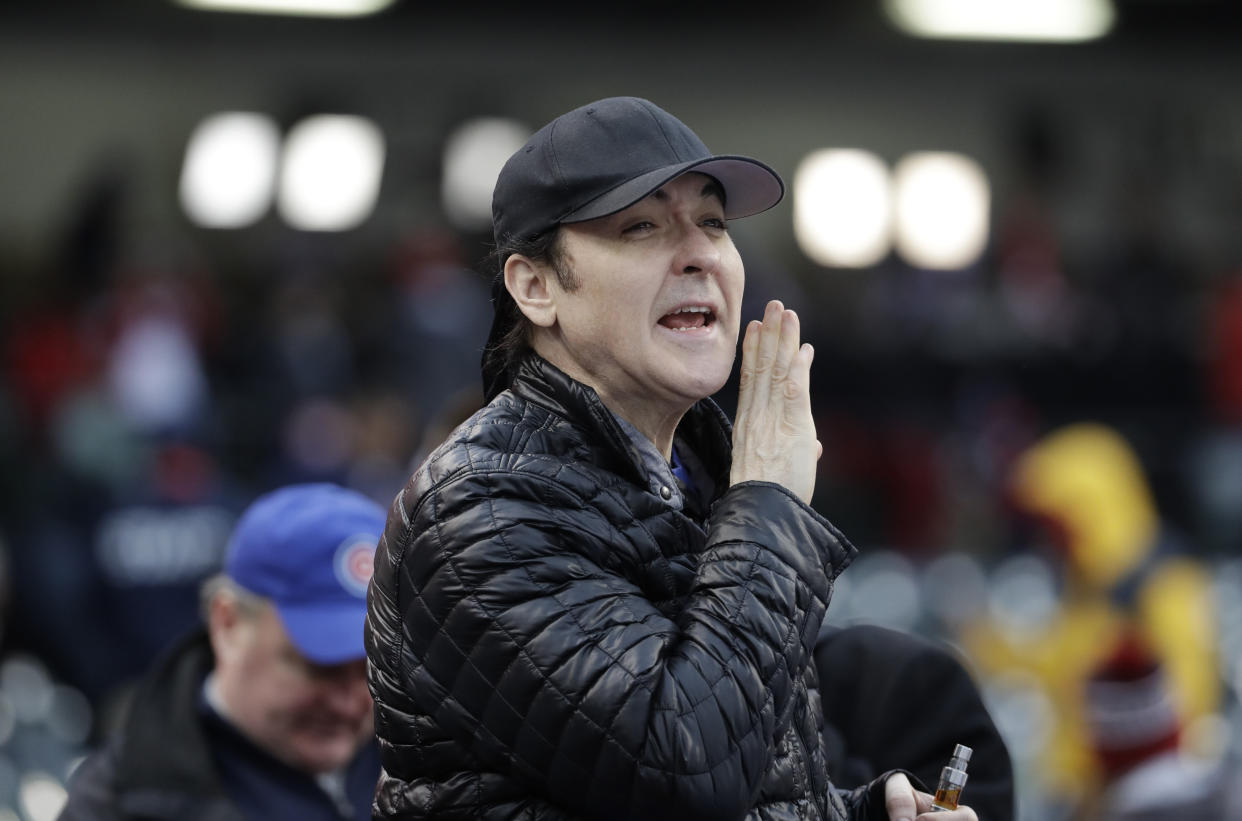 Actor John Cusack yells to some Chicago Cubs players before Game 2 of the Major League Baseball World Series against the Cleveland Indians Wednesday, Oct. 26, 2016, in Cleveland. (AP Photo/David J. Phillip)