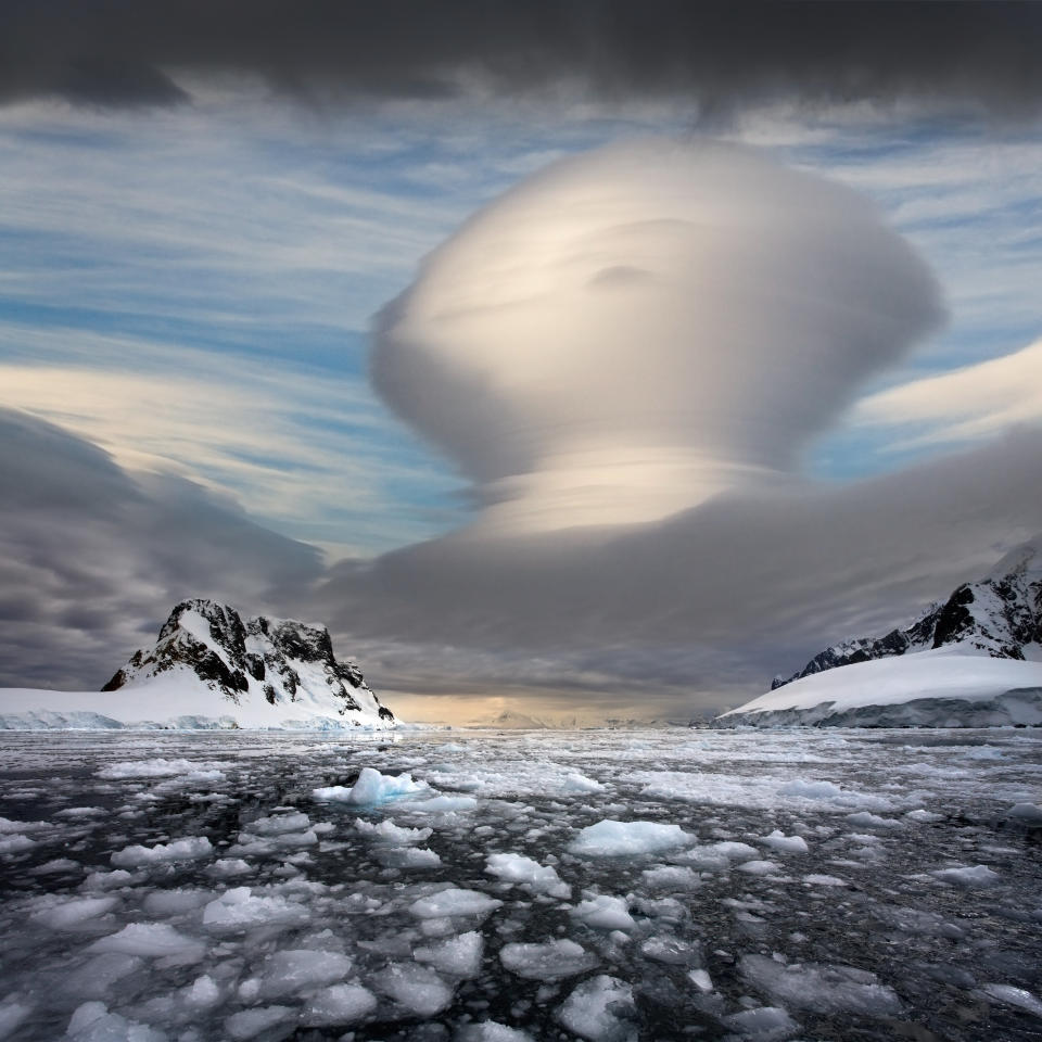 A lenticular cloud formation over the Lemaire Channel on the Antarctic Peninsula in Antarctica.