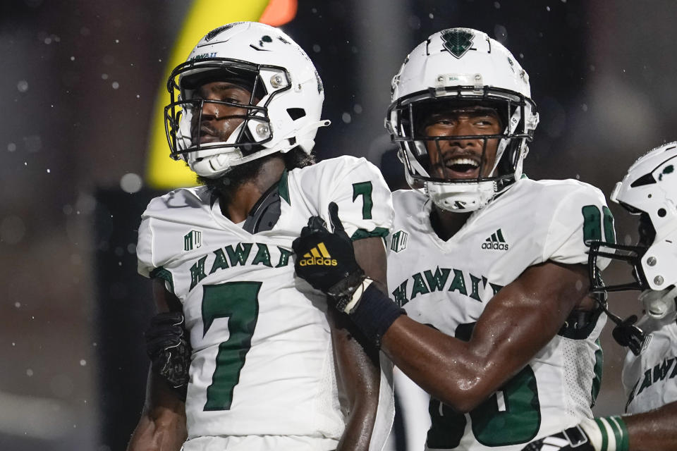 Hawaii wide receiver Steven McBride (7) is congratulated by wide receiver Pofele Ashlock after the team's touchdown against Vanderbilt in the first half of an NCAA college football game Saturday, Aug. 26, 2023, in Nashville, Tenn. (AP Photo/George Walker IV)