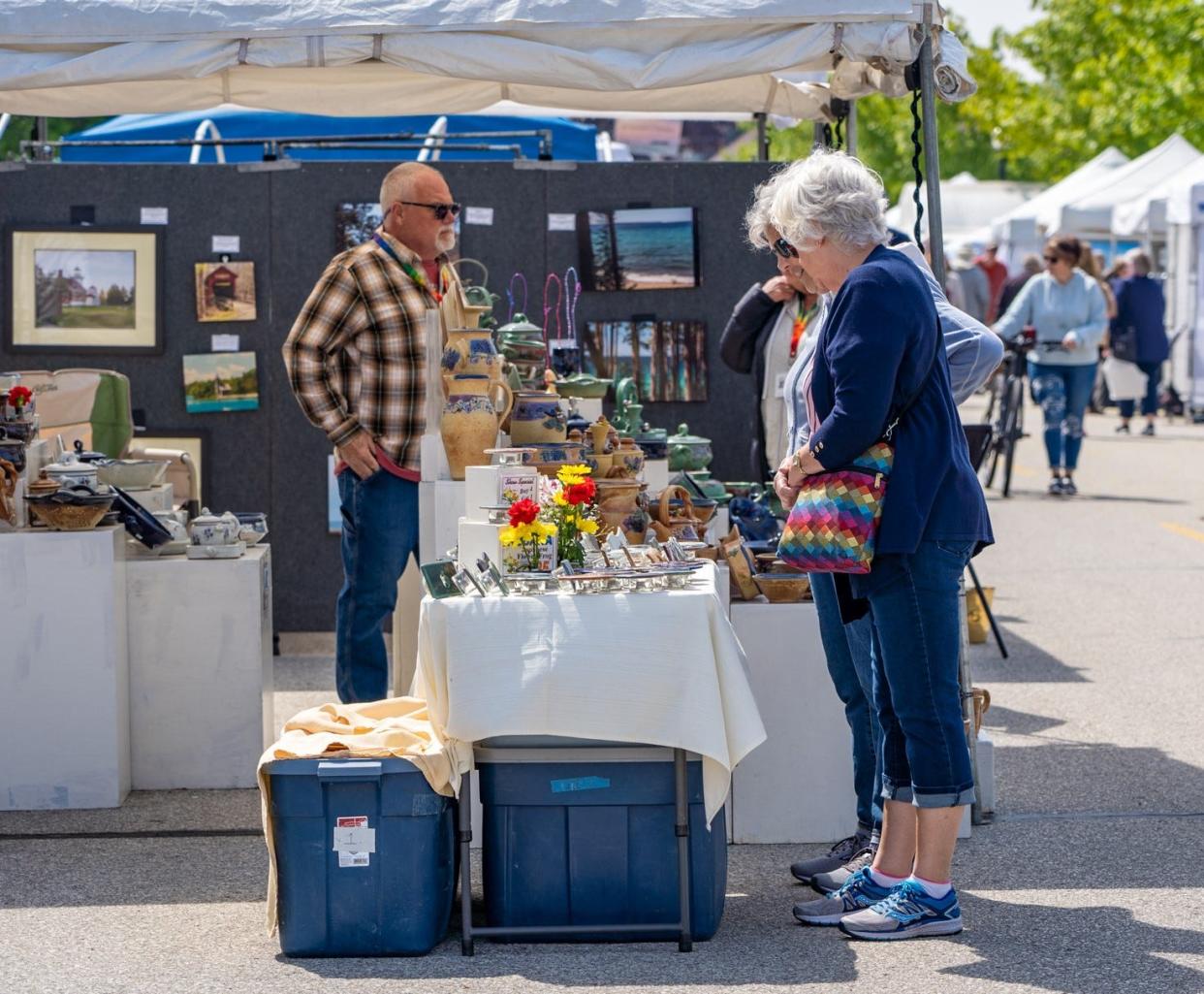 Visitors check out pottery made by hand by Curt Tortorella of Antioch Pottery at the 2023 Sturgeon Bay Fine Art Fair. This year's fair takes place May 25 and 26.