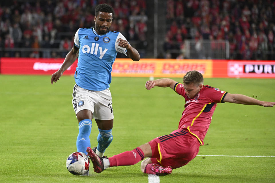 St. Louis City SC defender John Nelson, right, kicks the ball away from Charlotte FC defender Nathan Byrne during the second half of an MLS soccer match Saturday, March 4, 2023, in St. Louis. (AP Photo/Joe Puetz)