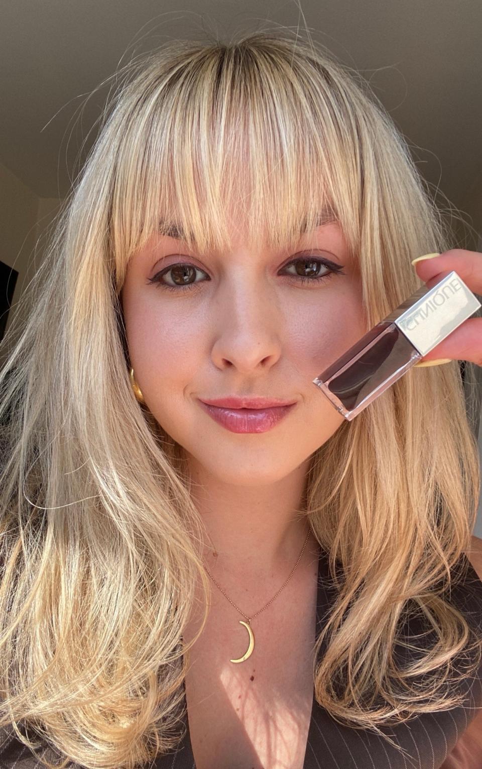 Allure editor Paige Stables is wearing Clinique Pop Lip + Cheek Oil in Black Honey on her lips and cheeks and Clinique High Impact Mascara in Black Honey on her lashes.