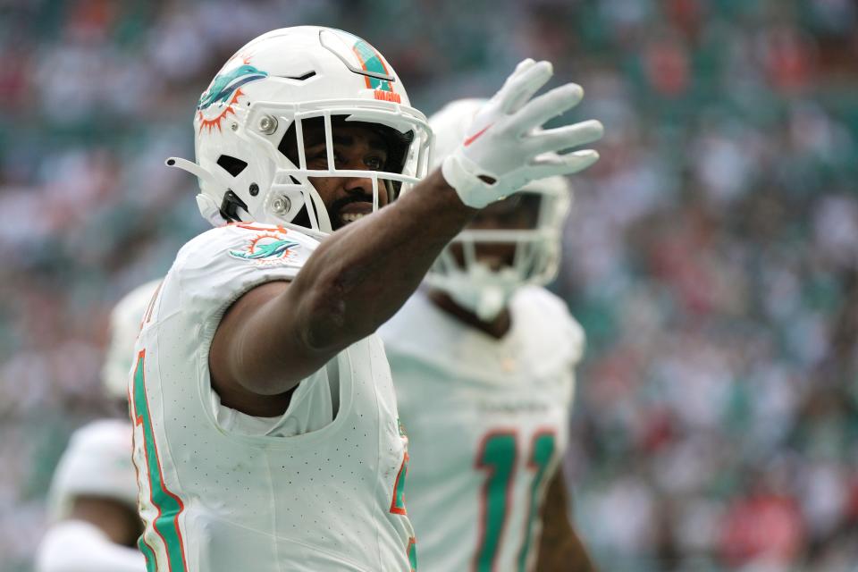 Dolphins running back Raheem Mostert blows a kiss to fans after scoring a touchdown.