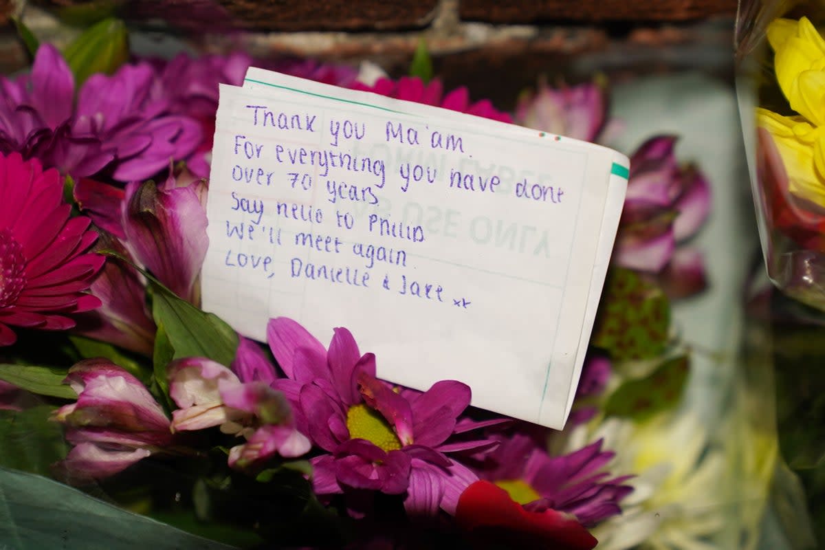 Floral tributes and messages left at the gates of Sandringham House (Joe Giddens/PA) (PA Wire)
