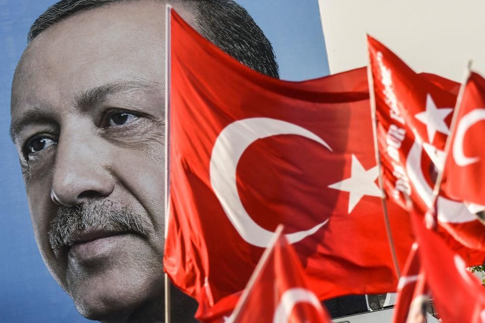 Turkish flags flutter next to a huge portrait of Turkey’s president and leader of the Justice and Development Party (AKP), Recep Tayyip Erdogan, as he gives a speech during an AKP preelection rally in Yenikapi Square in Istanbul on Sunday. (Photo: Aris Messinis/AFP/Getty)