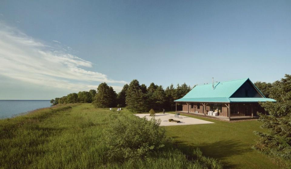 a building with a green lawn and trees by it