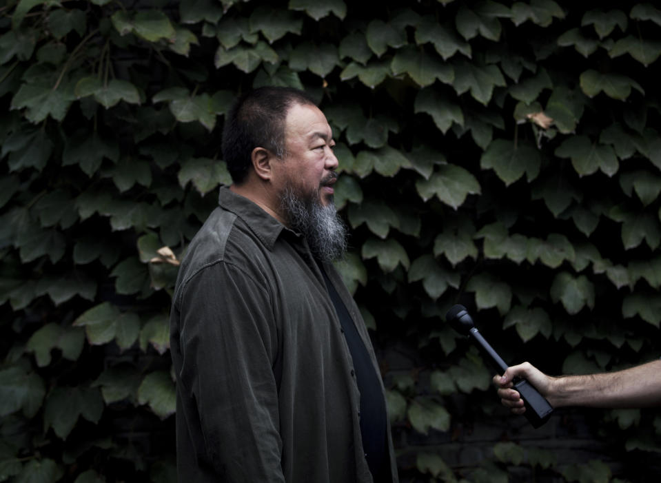 Chinese dissident artist Ai Weiwei speaks to a journalist at his studio, before he head to the Beijing No. 2 People's Intermediate Court for his appeal in Beijing Thursday, Sept. 27, 2012. Chinese authorities on Thursday rejected Ai's second and final appeal of a $2.4 million tax fine, a ruling he said sprang from a "barbaric and backward legal system." (AP Photo/Andy Wong)