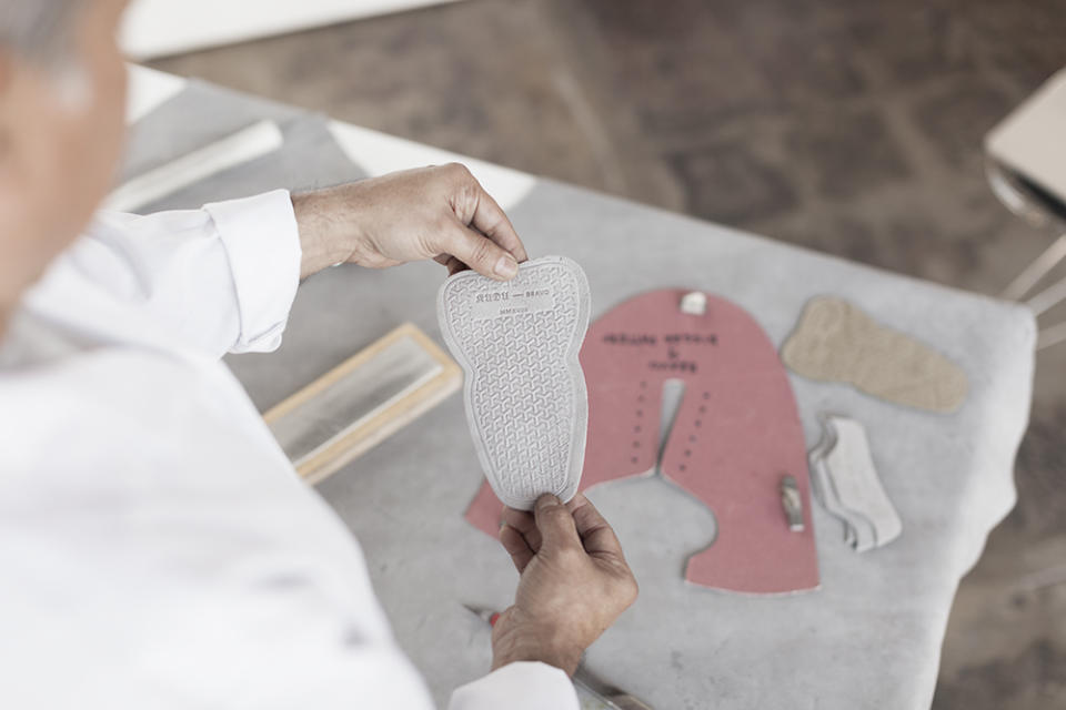 Checking the tongue of a sneaker being assembled at No.One.