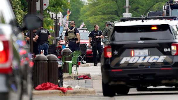 PHOTO: Law enforcement search in a building after a mass shooting at the Highland Park Fourth of July parade in downtown Highland Park, a Chicago suburb on Monday, July 4, 2022. (Nam Y. Huh/AP)