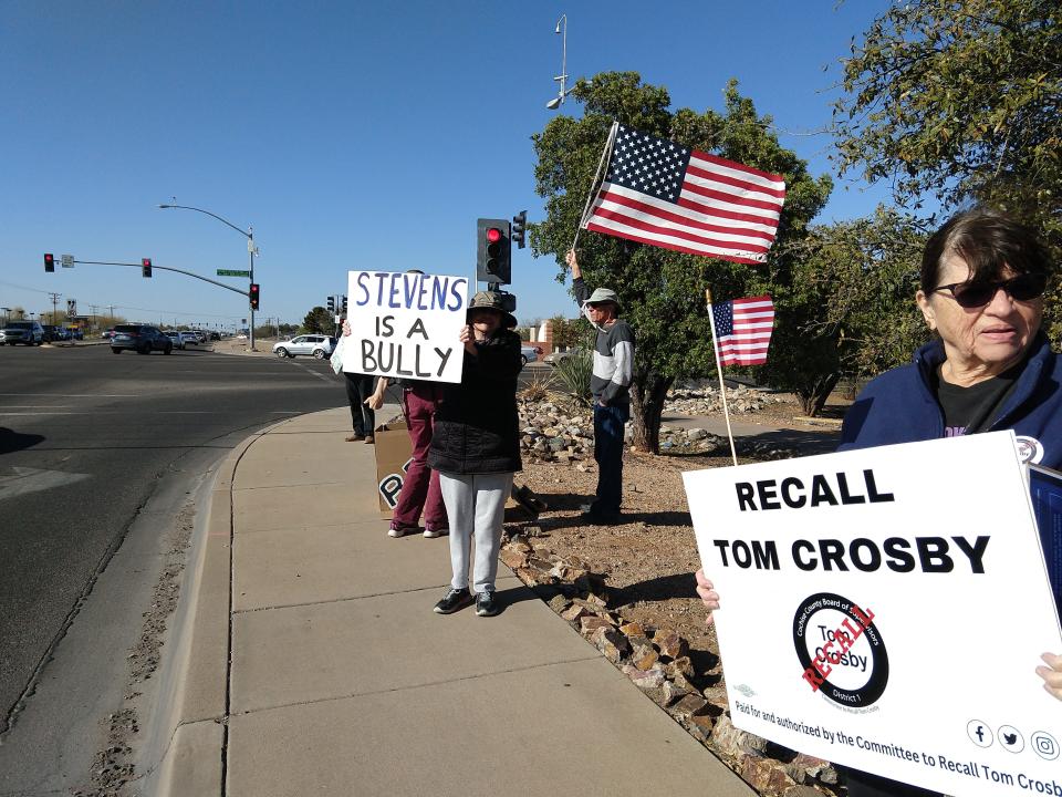 Supporters of the recall gather on April 4 with signs saying "Stevens is a bully" and "Recall Tom Crosby."