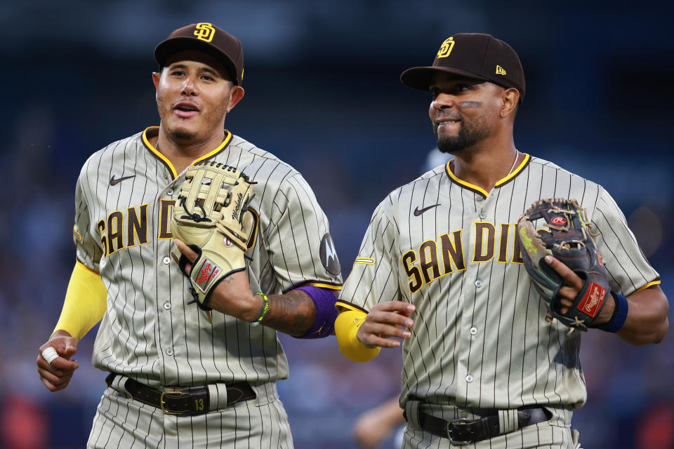 TORONTO, ON - JULY 18:  Manny Machado #13 and Xander Bogaerts #2 of the San Diego Padres run to the dugout in the third inning against the Toronto Blue Jays at Rogers Centre on July 18, 2023 in Toronto, Ontario, Canada.  (Photo by Vaughn Ridley/Getty Images)