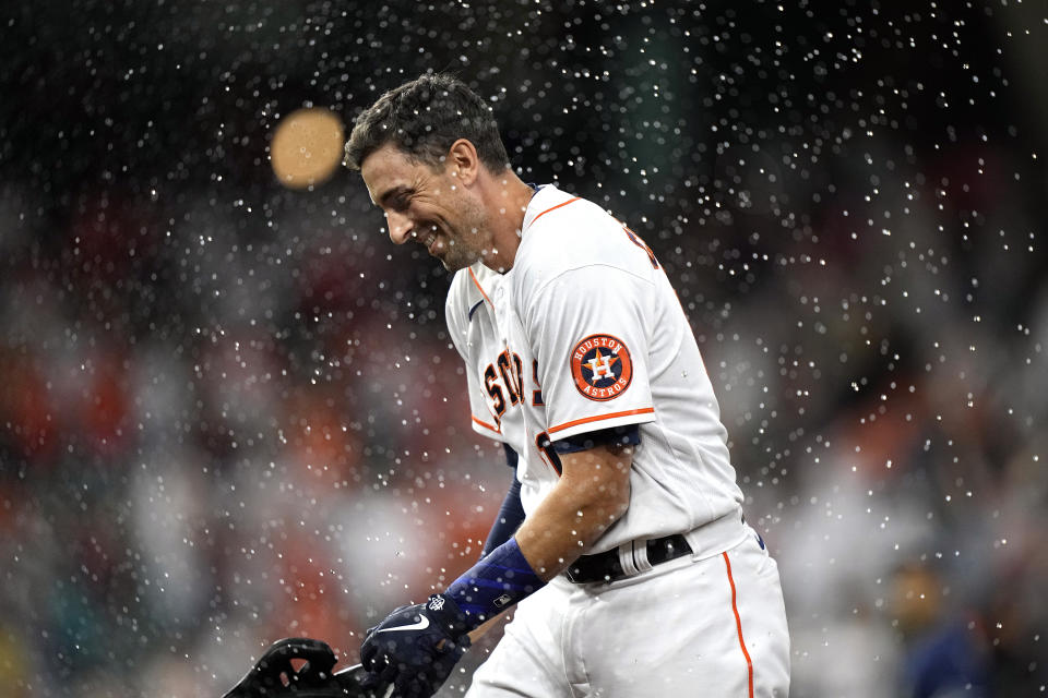 Houston Astros' Jason Castro celebrates after walking with the bases loaded to score Carlos Correa during the ninth inning of a baseball game against the Tampa Bay Rays Tuesday, Sept. 28, 2021, in Houston. The Astros won 4-3. (AP Photo/David J. Phillip)