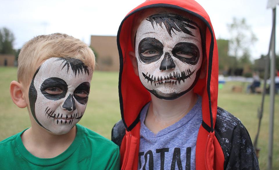 From left, twins Cohen and Jaxon Hill show off their painted faces at the 2019 Fall Fiesta in Gallatin.