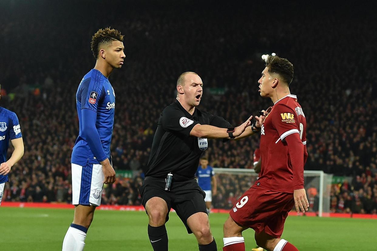 Firmino and Holgate clashed in the FA Cup: Liverpool FC via Getty Images