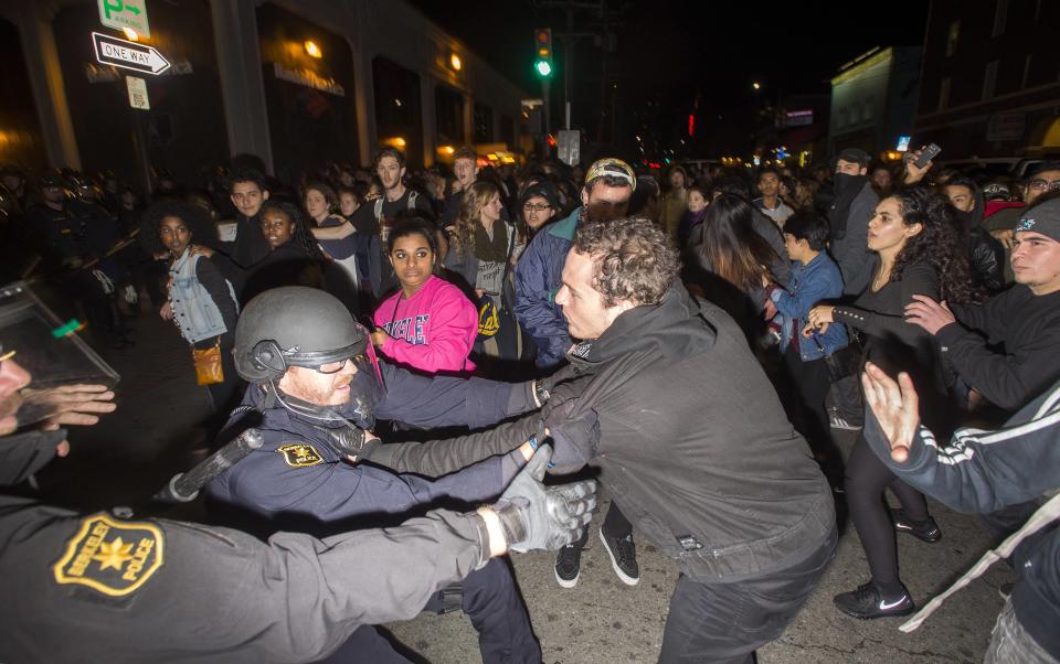 Police officers scuffle with protesters during a protest against police violence in the U.S., in Berkeley, California